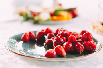 Fruits on a plate, Strawberry. Reception, catering. The table is covered with a white tablecloth. 