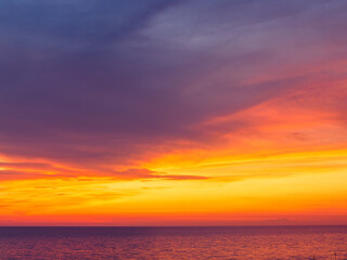 Naklejka na ściany i meble Amazing dramatic sunset sky over calm sea