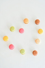 Cake macaron or macaroon on white background, sweet and colorful almond cookies with various pastel colors, vintage look. Different types of macaroons are a delicious dessert.