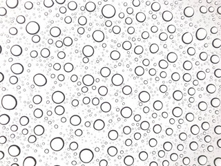 Fototapeta na wymiar Close up of water droplets on glass. Rain drops on white background