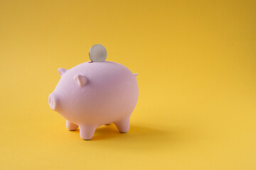 Piggy bank on yellow background.