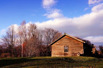 Fototapeta premium Old Wooden Cottage in the Autumn with Beautiful Blue Sky.