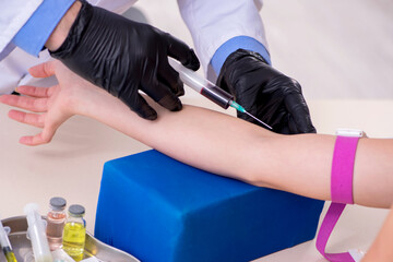 Young woman visiting old male doctor