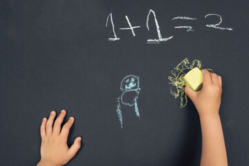 Kid drawing with chalk, close-up photograph of hands