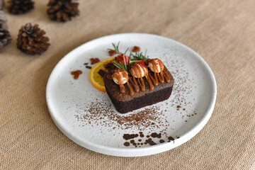 Top view chocolate brownies with on top Macadamia and caramel in the white dish on Sackcloth...