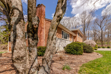 tri-level residential home with neat lawn and landscaping
