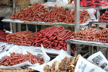 Meat products and street foods on table local shop in Zegyo Market at morning. Mandalay, Myanmar