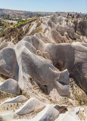 Aerial view of Goreme National Park, Tarihi Milli Parki, Turkey. The typical rock formations of Cappadocia with fairy chimneys and desert landscape. Travel destinations, holidays and adventure
