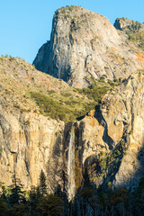 Sunset view of the bridalveil waterfall and Cathedral peak at the bottom of the Yosemite Valley