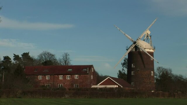 England countryside with windmill in Norfolk Broads UK