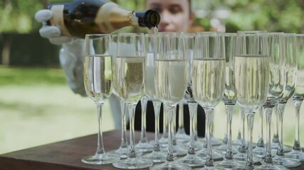 champagne being poured into a champagne flute by waitstaff