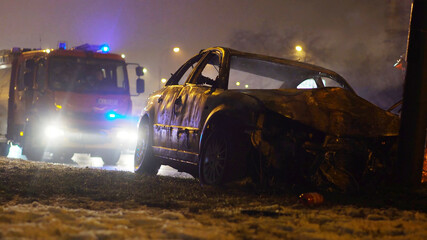 Fire truck on a scene of car collision with heavy damage
