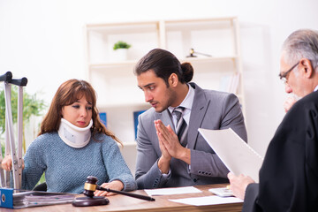 Young woman in courthouse with judge and lawyer