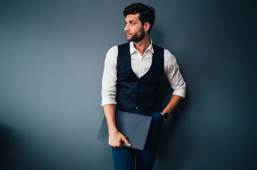 Young handsome businessman isolated on gray background