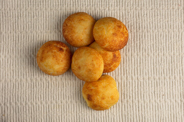 Typical colombian almojabanas, traditional colombian cheese bread over a white fabric. Traditional bakery