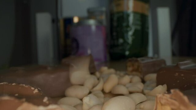 Macro close up view of the broken chocolate bar of chocolate with cashew nuts