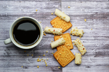 cup of aromatic coffee and cookies on a wooden board background