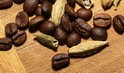 Black coffee beans and Green cardamom pods.
