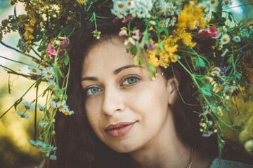 Girl in a wreath of wildflowers at the festival Midsummer