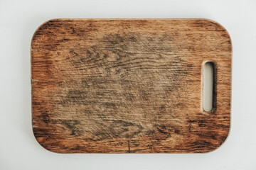 Old wooden cutting board on a white background. Top view. Copy, empty space for text