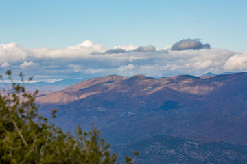 Sky with beautiful puffy white clouds and picturesque mountains, late autumn day in Northern...