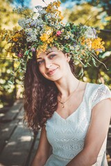 Girl in a wreath of wildflowers at the festival Midsummer
