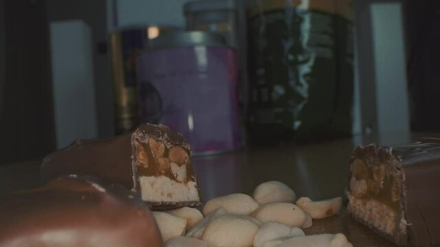 Macro close up view of the broken chocolate bar of chocolate with cashew nuts
