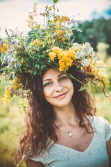 Girl in a wreath of wildflowers at the festival Midsummer