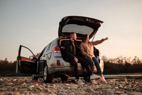 Young Couple Travel with a Car and Enjoys Ride, Weekend and Adventure Concept