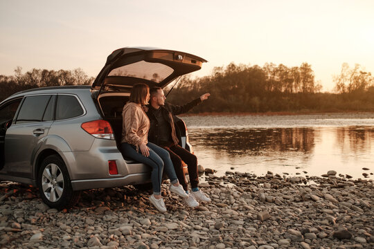 Young Couple Travel with a Car and Enjoys Ride, Weekend and Adventure Concept