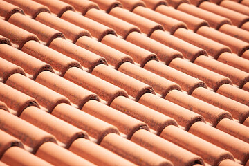 Closeup of orange red clay roof tile seamless pattern for house covering in red color