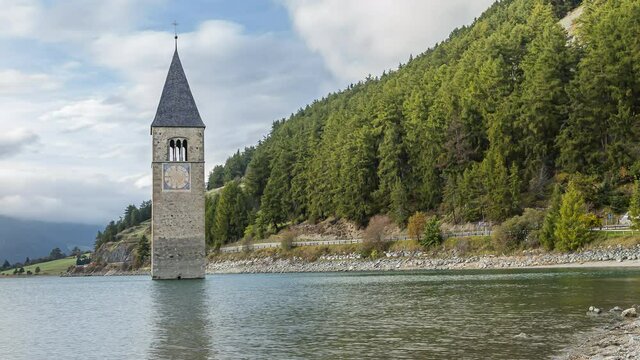 Reschenpass, Italy - October 12, 2014: Reschen lake is a reservoir in South Tirol.   The bell tower of the flooded village of Graun looks out of the water.