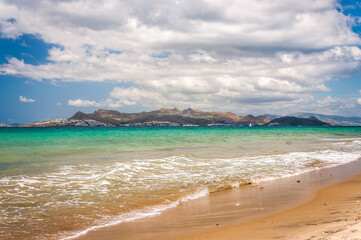 Beautiful golden sand beach with turquoise waters and a island and in the background. Kos island coast, Greece. Dodecanese islands.