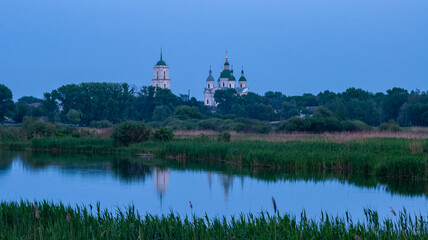 Fototapeta na wymiar Monastery over the evening lake