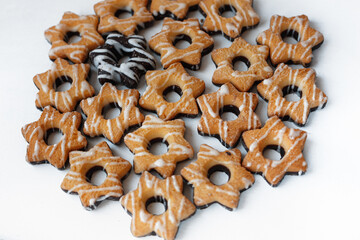 A pile of star shaped biscuit cookies isolated on white