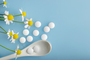 Pharmaceutical medical pills, yellow pills with chamomile flower, natural medicine concept. Soothing preparations