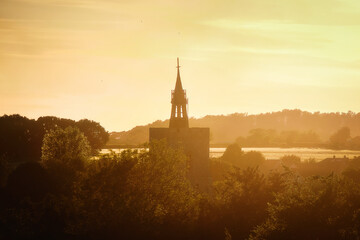 Sunset over the silhouette of the tower church in a English village of Boxford, Suffolk, England