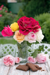 Bouquet of roses of different varieties against the background of nature