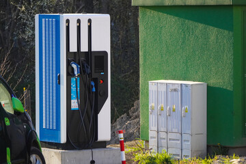 Charging station for electric cars of different types. Operation of electric vehicles. Transformer station near the Parking lot of electric cars.