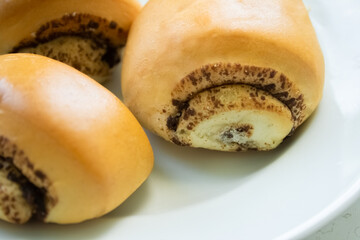 Cinnamon rolls on a white plate close-up