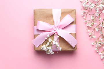 Baby's breath flowers and a gift box with a pink ribbon on a pink background, close-up. Wedding design, greetings, invitations, Wallpapers.