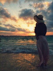 silhouette of a girl on the beach at sunset