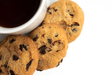 White cup of tea with cookies with chocolate chips on a white background