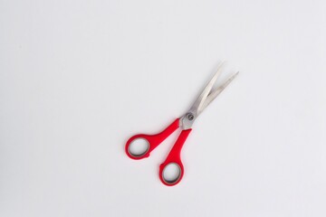 one pair of scissors with pink handles on a light background