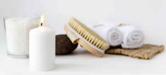 Fototapeta na wymiar Eco set for spa treatments at home with towels, pumice, salt, candle on a white background.