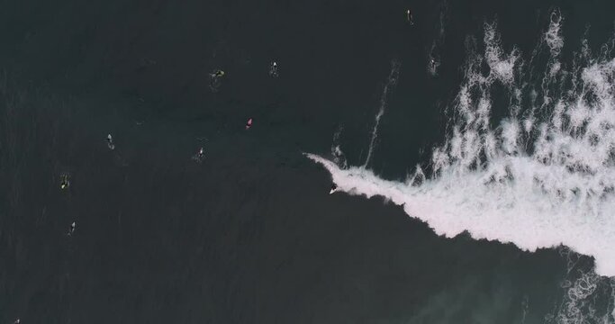 People surfing in a volcanic beach