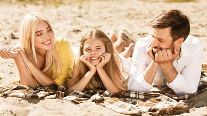 Family Relaxing Lying On Plaid Having Picnic Outside, Panorama