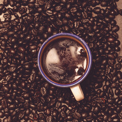 Taza de café y granos de café tostado en ángulo cenital