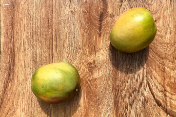 Mango fruits over wooden background