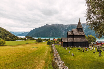 Reconstructed wooden church in Norway with cemetery.